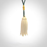 Hand carved Kowhai flower. These are made from Woolly Mammoth tusk and are a soft golden brown colour. They are provided with a hand plaited, adjustable cord. Shipping is free worldwide.